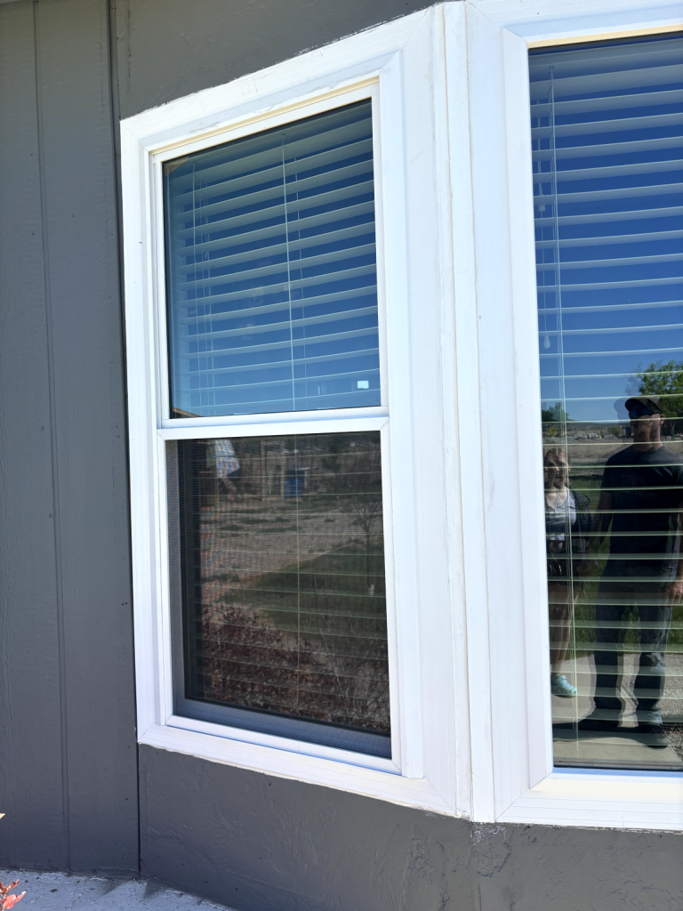 Window reflecting surroundings and people