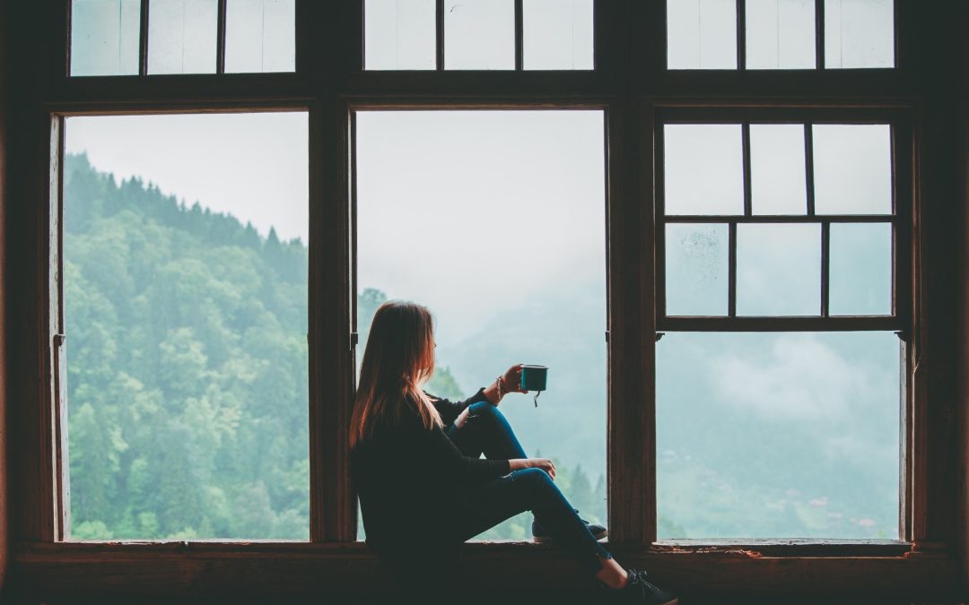 Woman enjoying coffee by window
