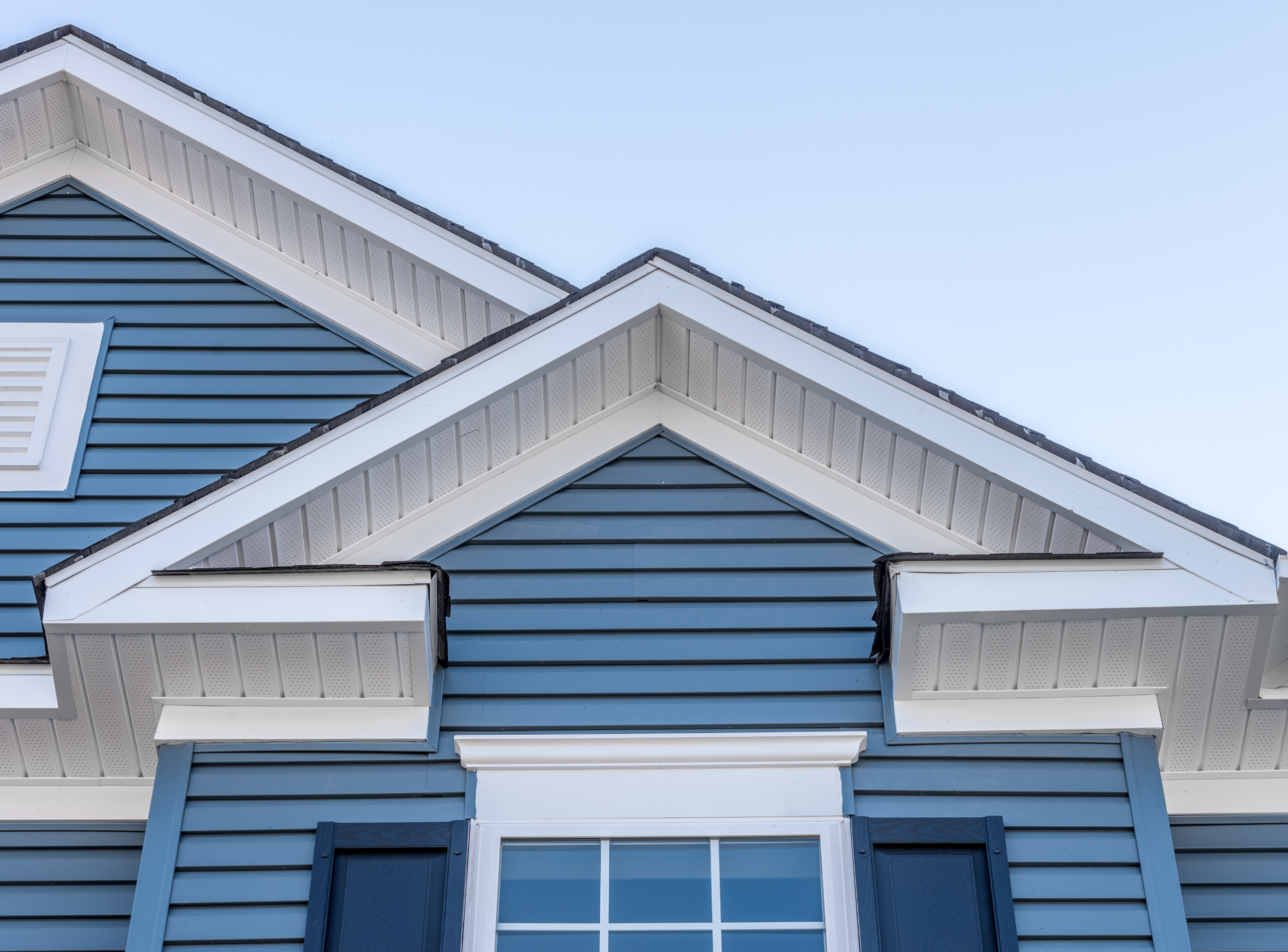 a house with a window and a stone garden
