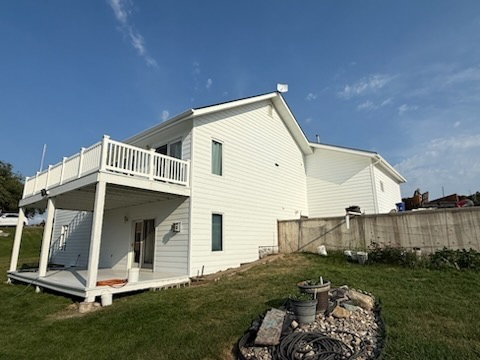 White house with balcony and yard
