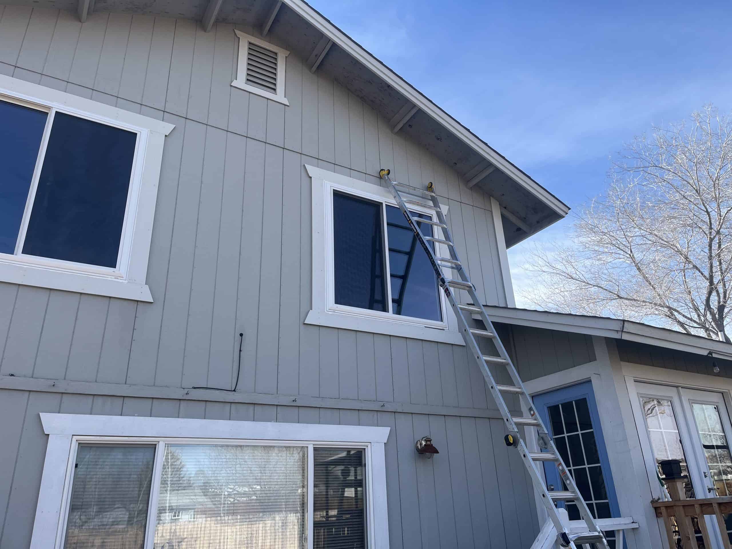 Exterior view of a house with new NTY Windows and a ladder.