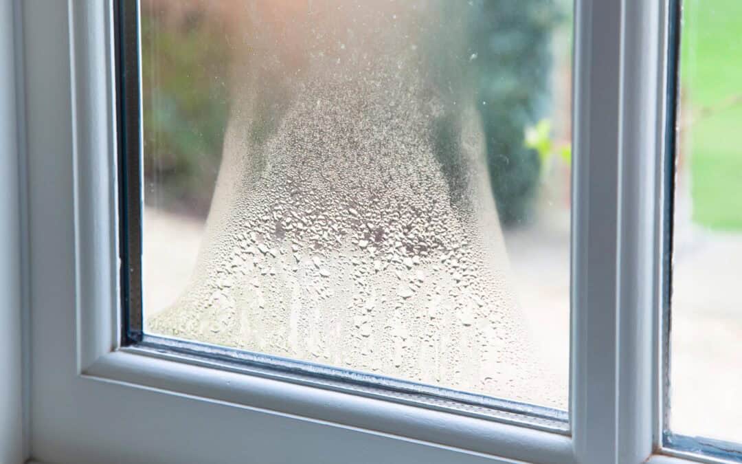 Frosted window with condensation, showcasing double-glazed glass for insulation.