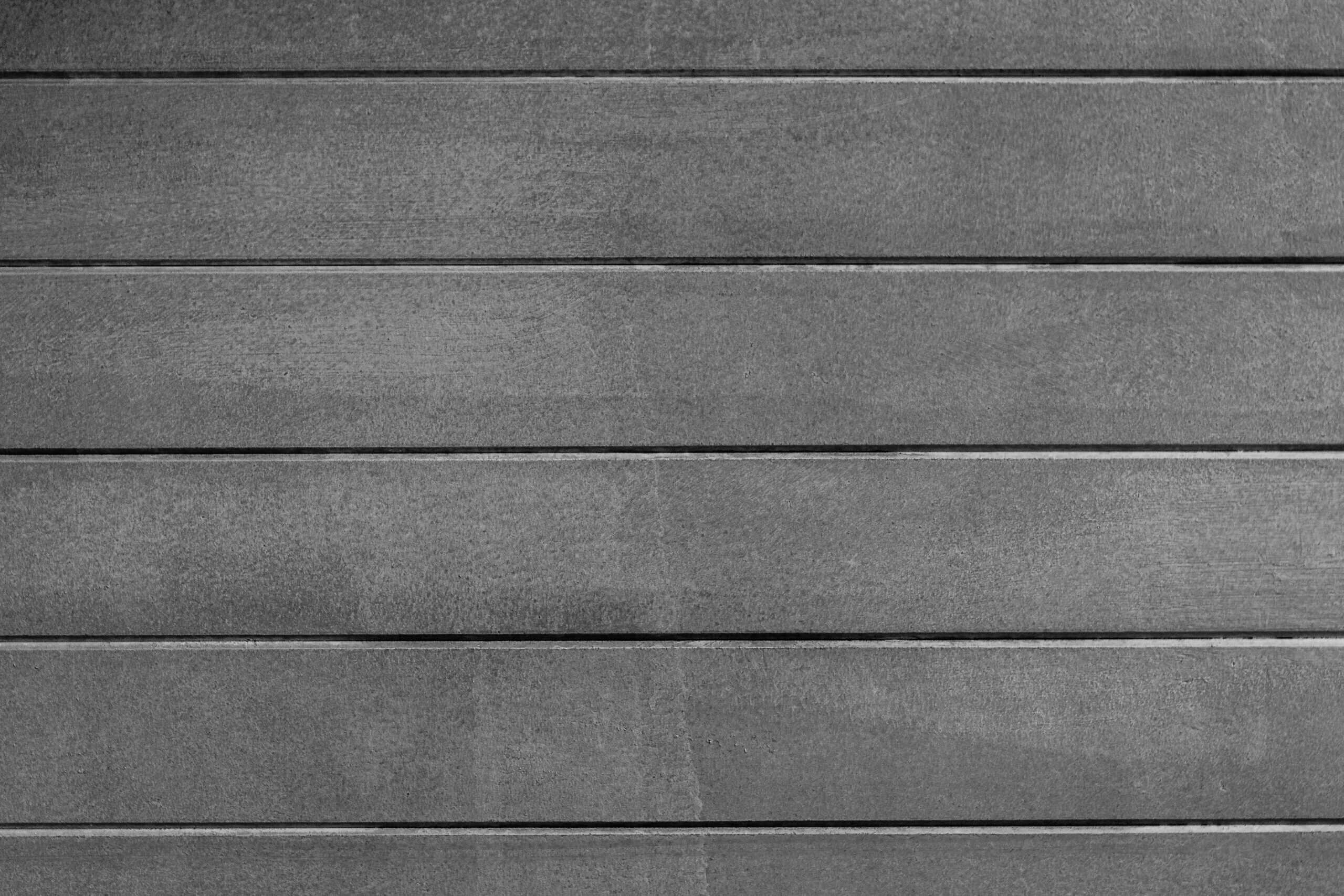Close-up of gray horizontal siding panels for windows and exterior walls.