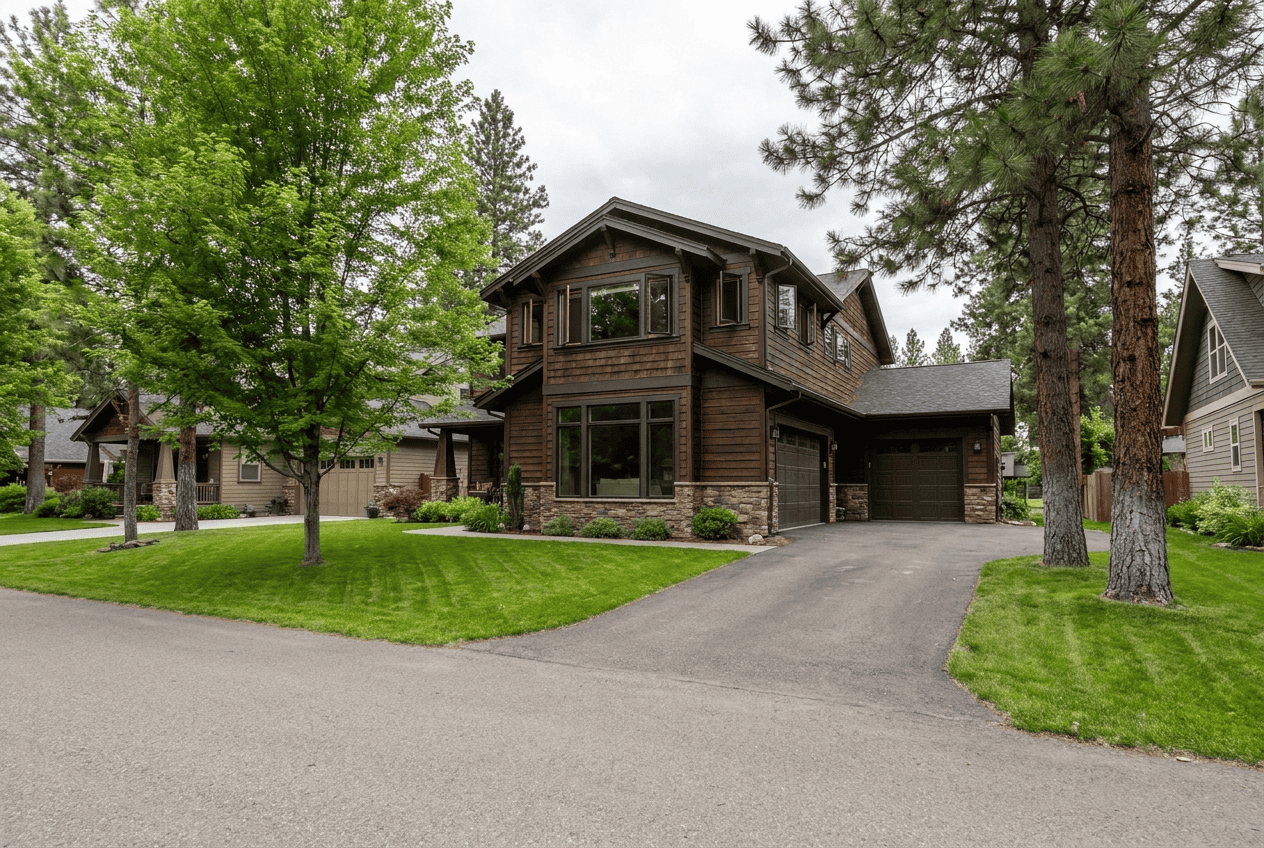 Contemporary house with large windows and a well-maintained lawn in a suburban neighborhood.